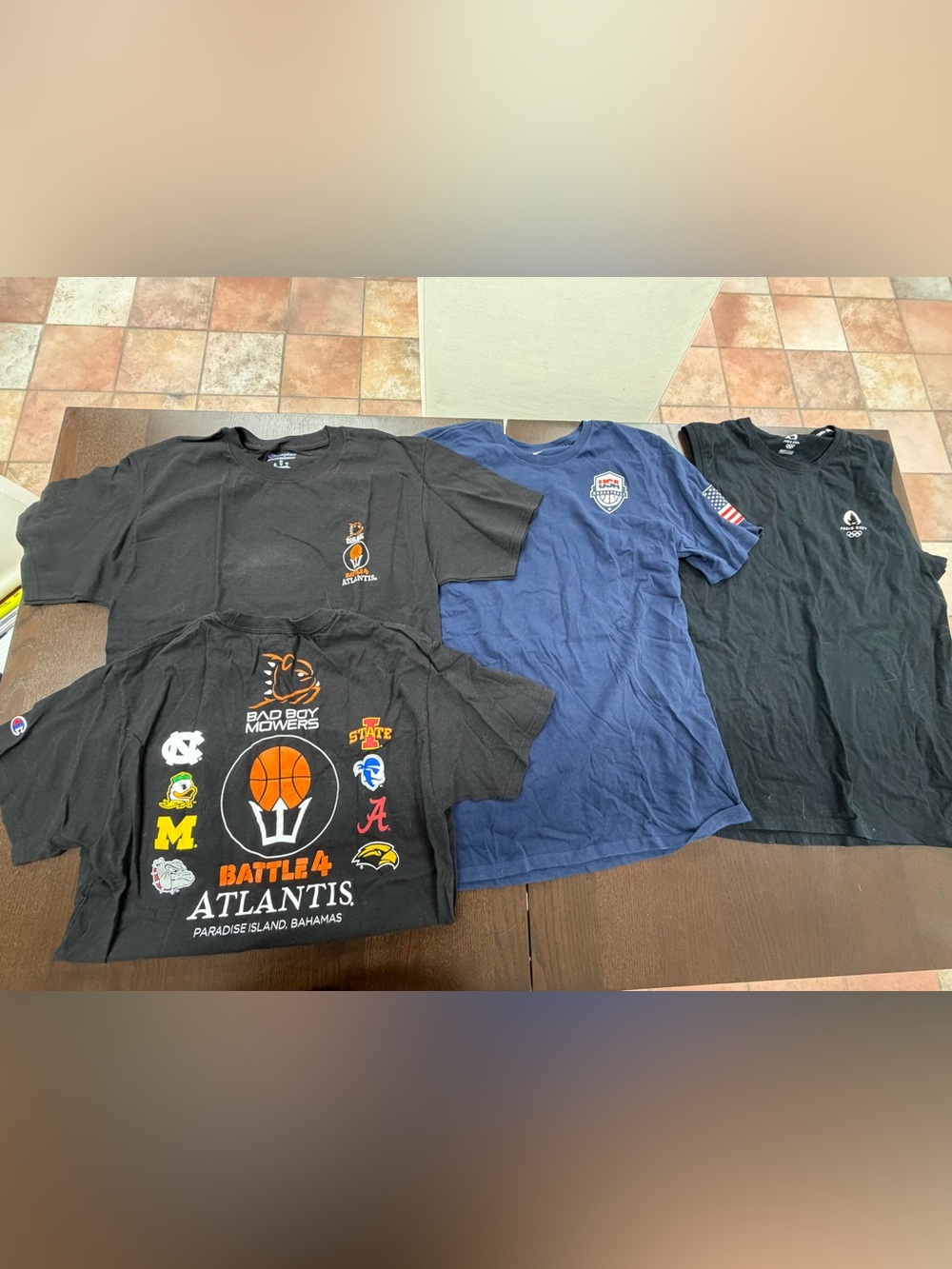 Three size medium tee shirts and one size large tank top